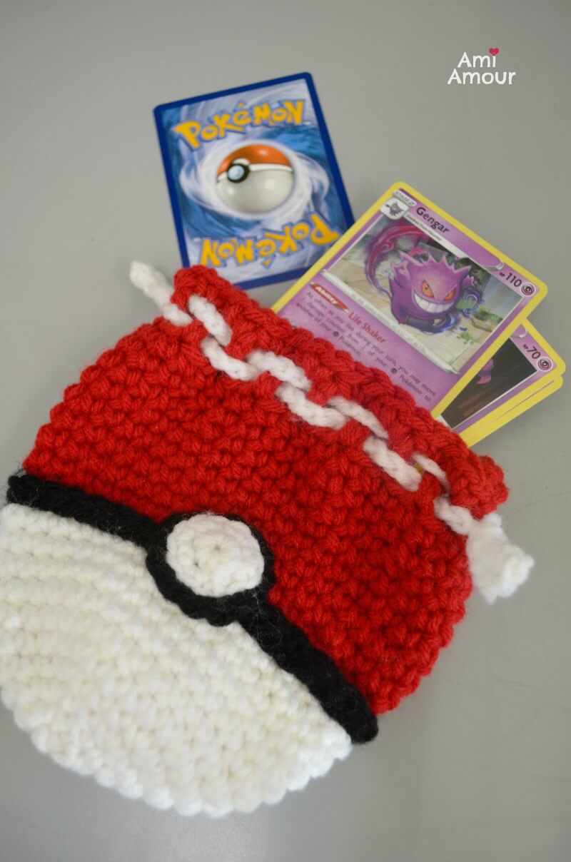 Close-up of crochet Pokeball bag construction and drawstring area